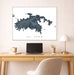 Map of St. John on a wall above a desk with a laptop and lamp.