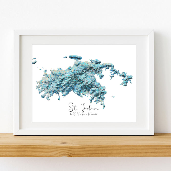 Framed map print of St. John, U.S. Virgin Islands with a white frame on a wooden surface.