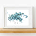 Framed map print of St. John, U.S. Virgin Islands with a white frame on a wooden surface.