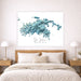 Framed map of St. John, US Virgin Islands on a wall above a bed.