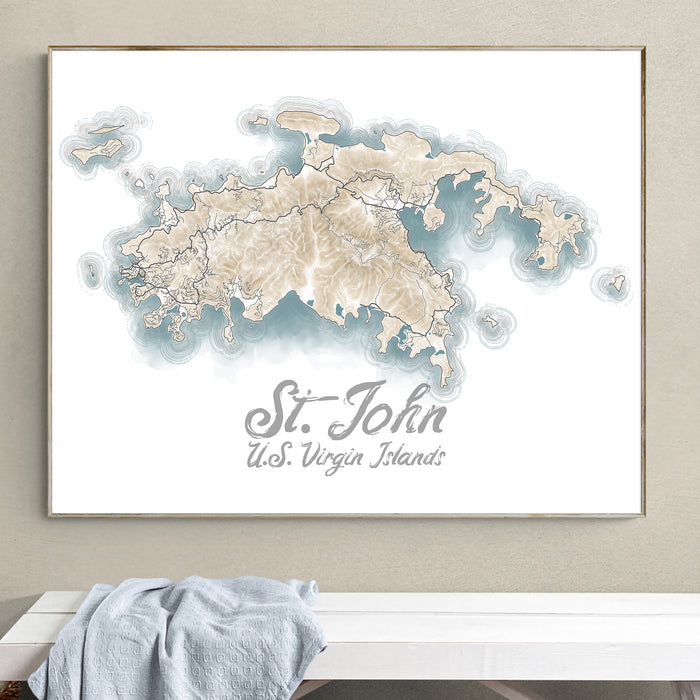 Framed contour map of St. John, U.S. Virgin Islands on a wall above a white surface.