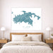 Framed map of St. John, US Virgin Islands on a wall above a bed.