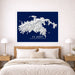 Framed map of St. John, United States Virgin Islands on a wall above a bed.