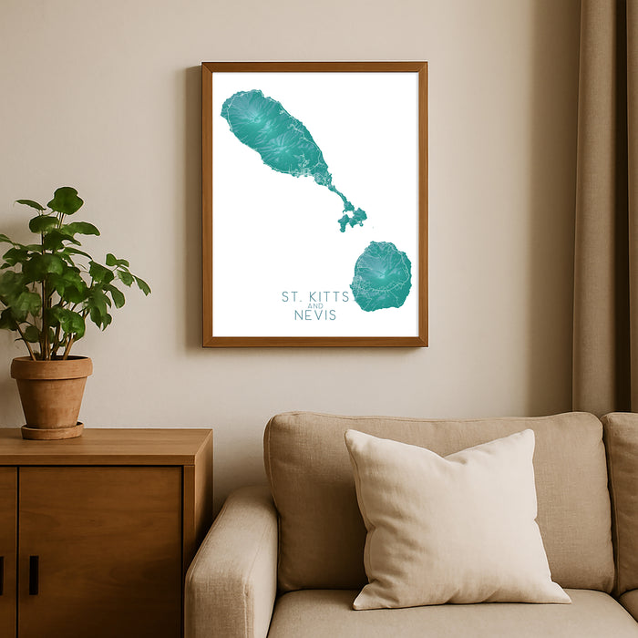 Framed map of St. Kitts and Nevis on a wall above a beige sofa with a plant beside it.