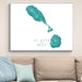 Framed map of St. Kitts and Nevis on a wall above a sofa.