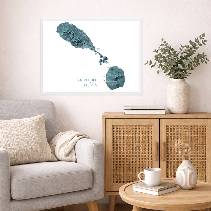 Living room with a map of Saint Kitts and Nevis on the wall, a beige sofa, wooden cabinet, and small table.