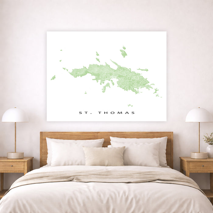 Map of St. Thomas on a wall above a bed in a bedroom setting