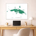 Framed map of St. Thomas on a wall above a desk with a laptop and lamp.