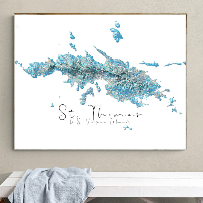 Framed map of St. Thomas, US Virgin Islands on a wall above a white bench.