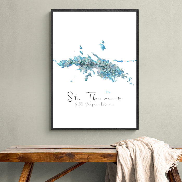 Framed map of St. Thomas on a wall above a wooden bench.