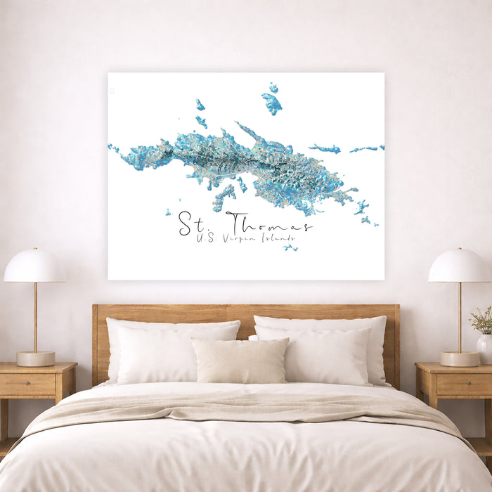 Map of St. Thomas US Virgin Islands on a wall above a bed with wooden headboard and nightstands.