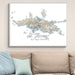 Framed map of St. Thomas, U.S. Virgin Islands on a wall above a beige sofa with light blue pillows.