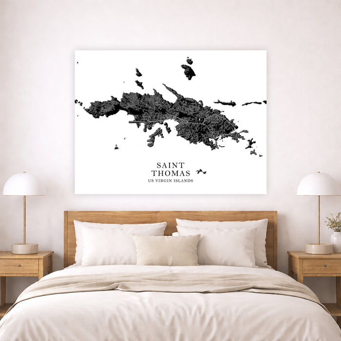 Map of Saint Thomas on a wall above a bed in a bedroom setting