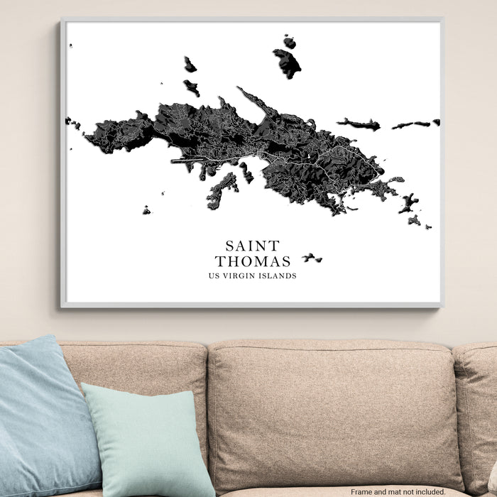 Framed map of Saint Thomas, US Virgin Islands on a wall above a beige sofa.