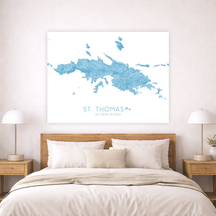 Map of St. Thomas on a wall above a bed in a bedroom setting