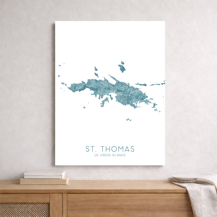 Map of St. Thomas, US Virgin Islands on a white wall above a wooden surface.