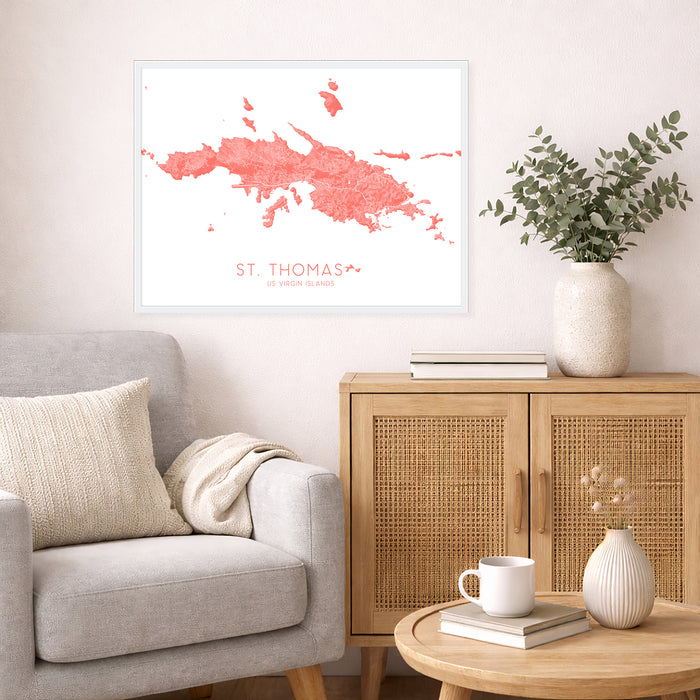 Living room with a map of St. Thomas on the wall, a couch, and a side table with decor items.