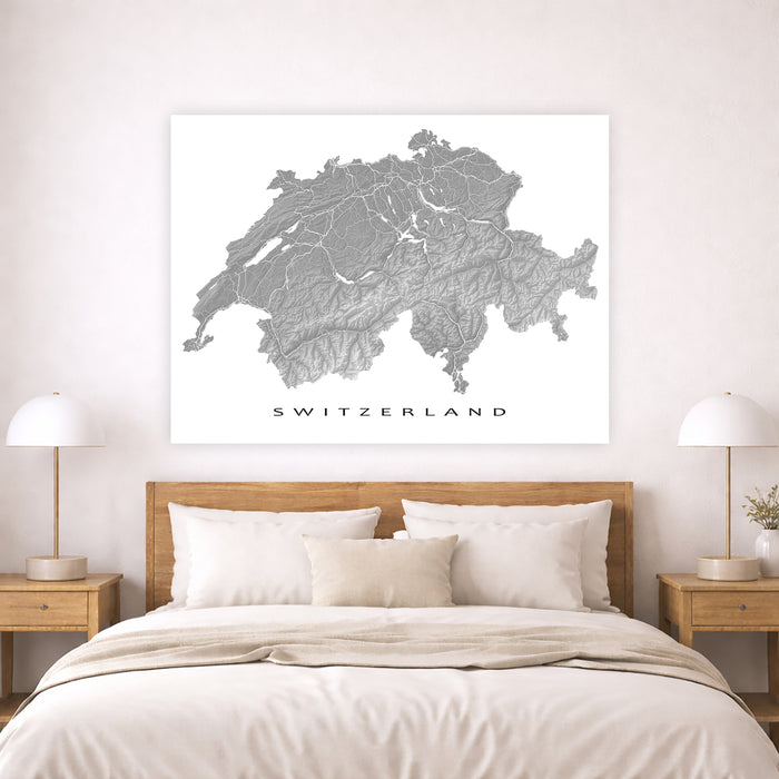 Map of Switzerland on a wall above a bed in a bedroom setting