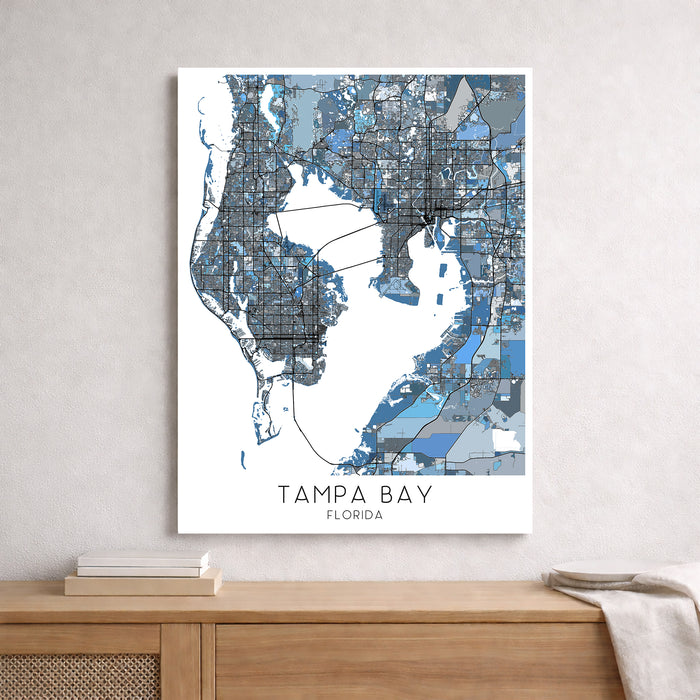 Framed map of Tampa Bay, Florida on a wall above a wooden surface.