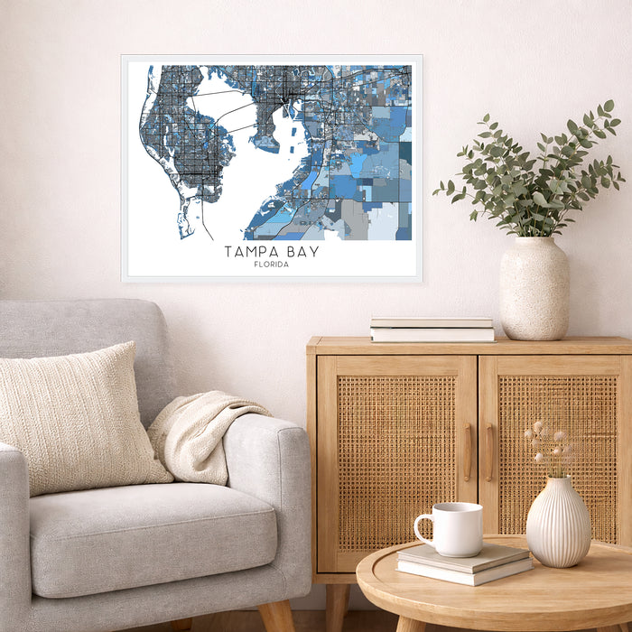 Living room with a map of Tampa Bay, Florida on the wall above a sofa and side table.