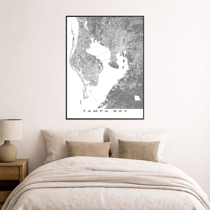 Framed map of Tampa Bay above a bed in a bedroom