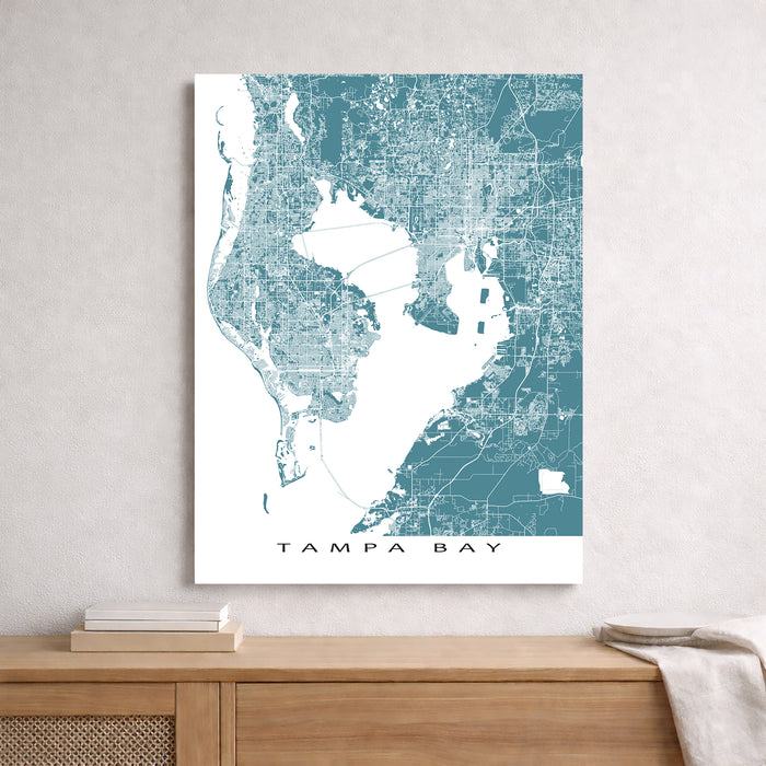 Map of Tampa Bay on a wall above a wooden shelf.