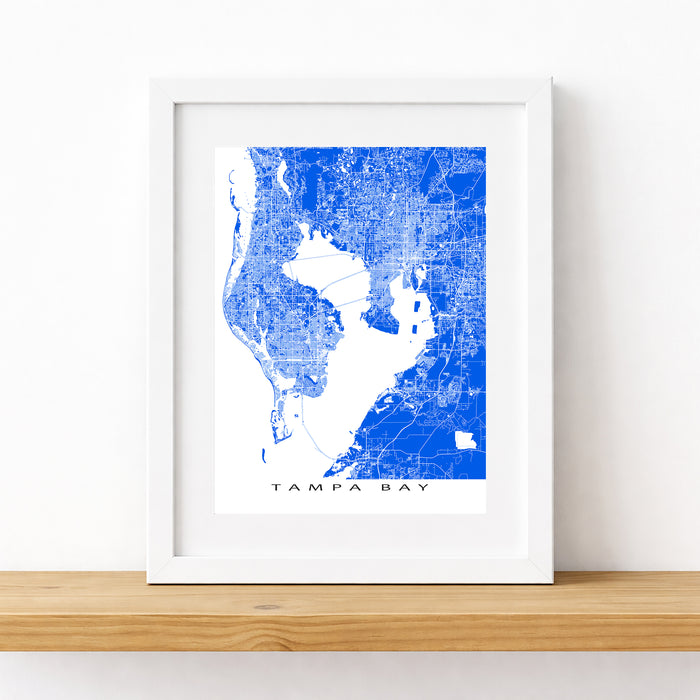 Framed map of Tampa Bay with a blue and white color scheme on a white wall.