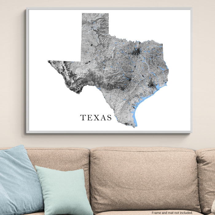 Framed map of Texas on a wall above a sofa