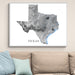 Framed map of Texas on a wall above a sofa