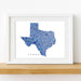 Framed map of Texas with a blue mosaic pattern on a white background