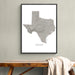 A framed gray map print of Texas hangs on a light gray wall above a wooden bench with a draped cream throw blanket.