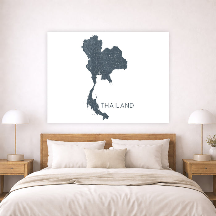Map of Thailand on a wall above a bed in a bedroom setting