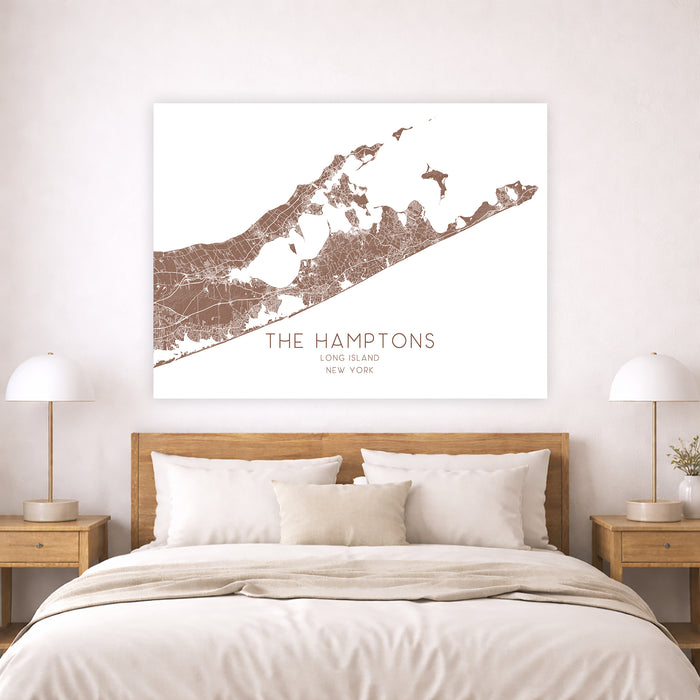 Map of The Hamptons on a wall above a bed in a bedroom.