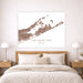 Map of The Hamptons on a wall above a bed in a bedroom.