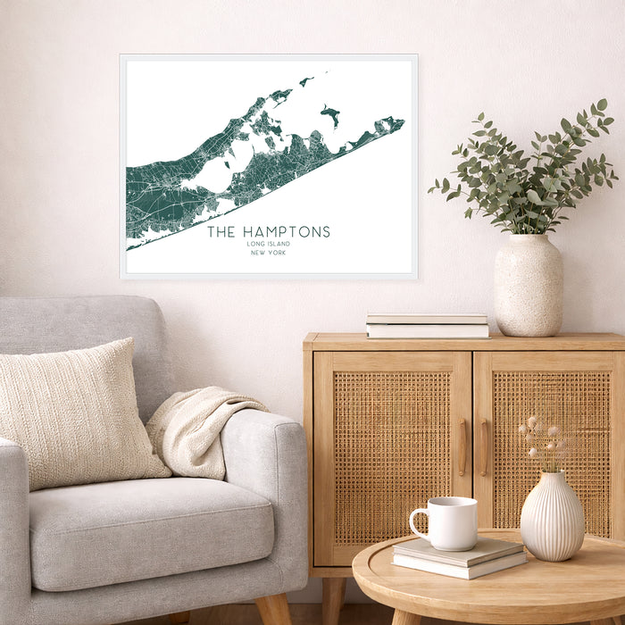 Living room with a map of The Hamptons on the wall, a couch, and a side table with decor items.