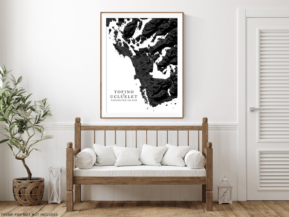 Wooden bench with white cushions in a room with a framed black and white map of Tofino on the wall.