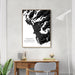 Framed black and white abstract art print on a wall above a desk.