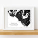 Framed map print of Tofino and Ucluelet on Vancouver Island, displayed on a wooden surface.