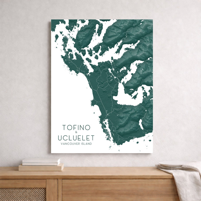 Map of Tofino and Ucluelet on Vancouver Island displayed on a wall above a wooden shelf.