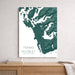 Map of Tofino and Ucluelet on Vancouver Island displayed on a wall above a wooden shelf.