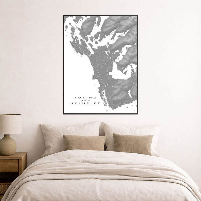 Framed map of Tofino and Ucluelet above a bed in a bedroom