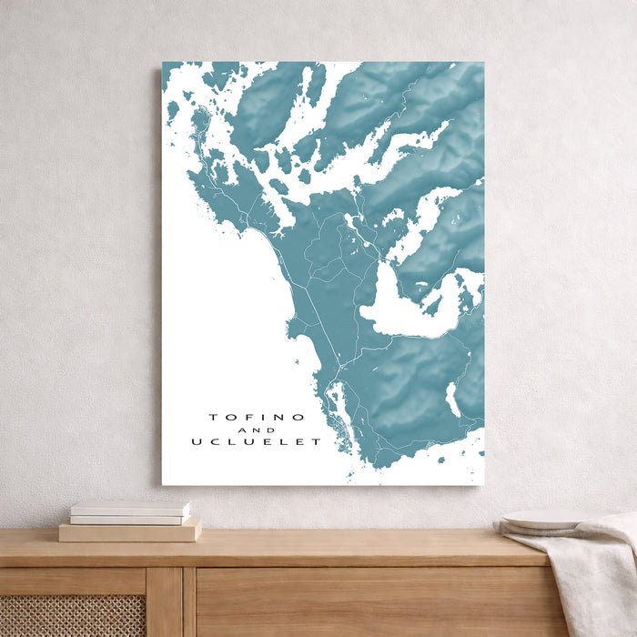 Map of Tofino and Ucluelet on a wall above a wooden shelf.