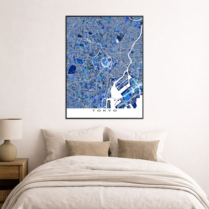 Framed map of Tokyo on a wall above a bed