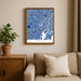 Framed map of Tokyo on a wall above a beige sofa with a plant beside it.