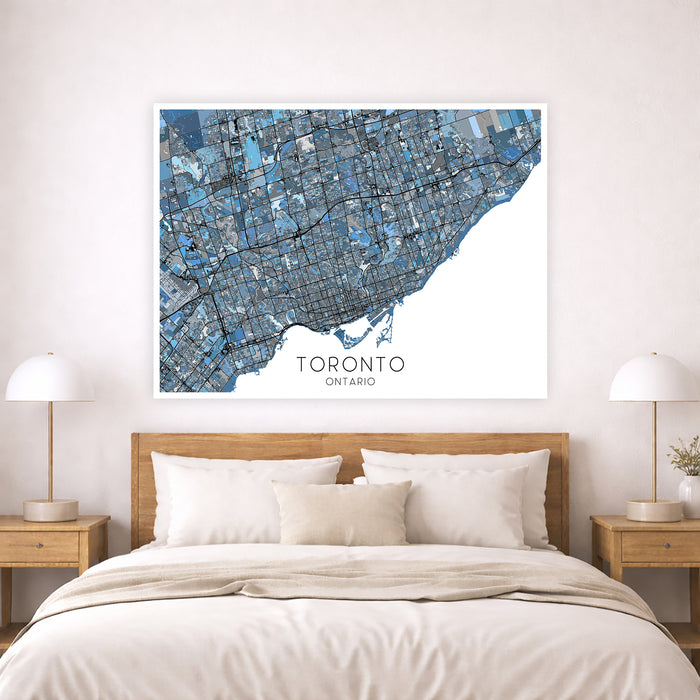 Framed map of Toronto on a wall above a bed in a bedroom.