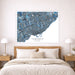 Framed map of Toronto on a wall above a bed in a bedroom.
