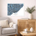 Living room with a city map of Toronto on the wall, a beige sofa, wooden cabinet, and decorative items.