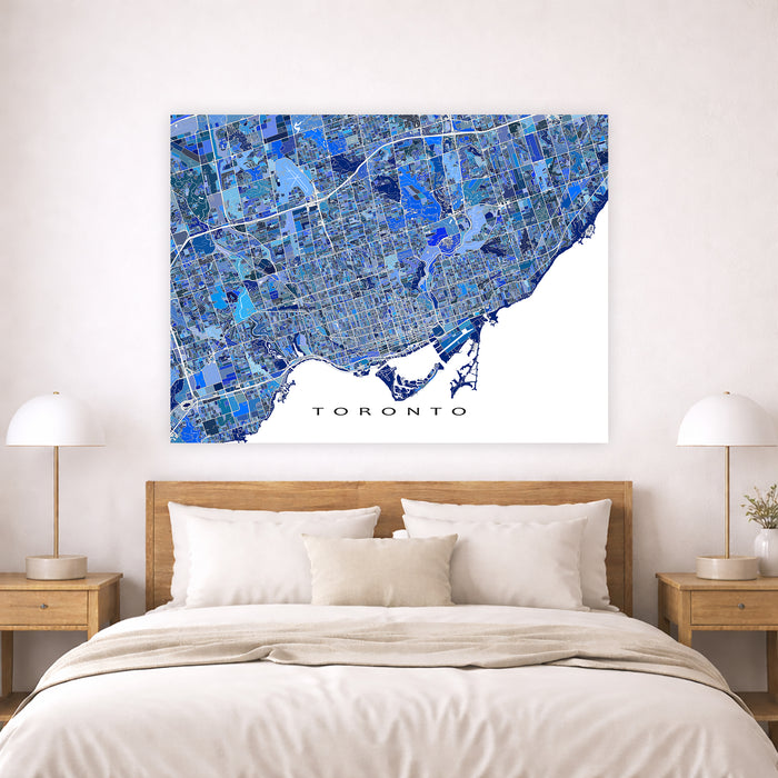 Map of Toronto on a wall above a bed in a bedroom setting