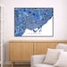 Framed map of Toronto on a wall above a wooden cabinet and sofa.