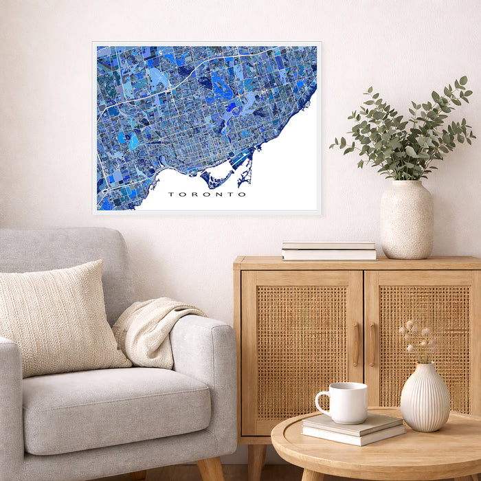 Living room with a map of Toronto on the wall, a couch, and a side table with decor items.